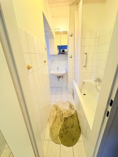 a bathroom with a tub and a sink and a toilet at Beenie 19 in Linz