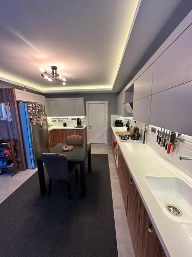 a large kitchen with a table and a sink at Villa Dream in Kuşadası