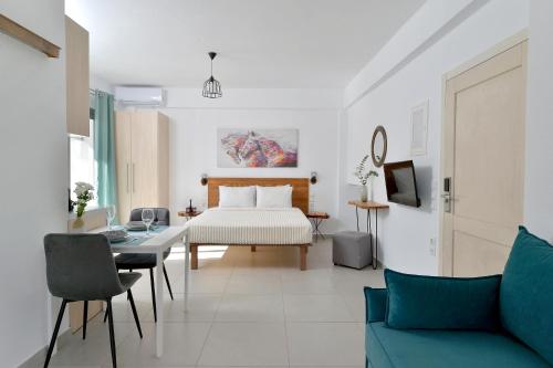 a living room with a bed and a table at SunDay Free Airport Shuttle in Artemida
