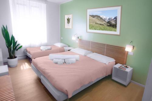 a bedroom with two beds with pink sheets at Il Giardino di Gioia in Verona