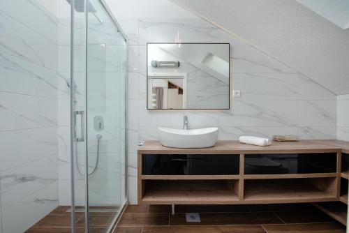 a bathroom with a sink and a glass shower at Villa Maris in Povlja