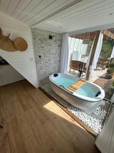 a bath tub sitting inside of a room at Cabana Branca luxo in Teresópolis