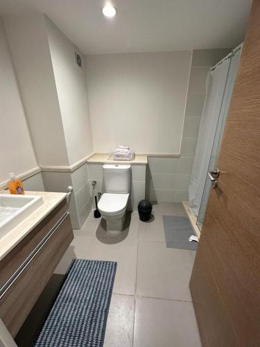 a small bathroom with a toilet and a sink at Marina Marassi in El Alamein