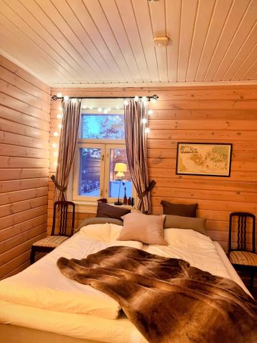 a bedroom with two beds and a window at Private archipelago villa with large property in Pargas