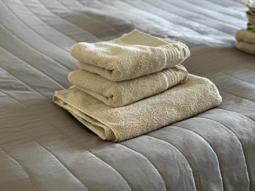 a stack of towels sitting on a bed at Deck 8 in Timmendorfer Strand
