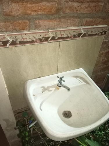 a white sink sitting on a brick wall at Los eucaliptos in Andino