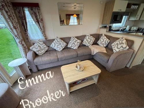 a living room with a couch and a table at Lapwing 32 Cayton Bay in Scarborough