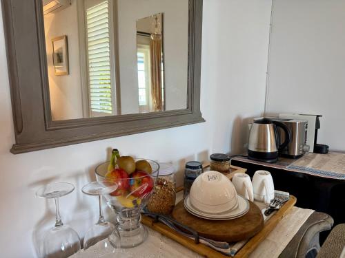 a table with a bowl of fruit and a mirror at Villa Victoria - Nelson in Nelson