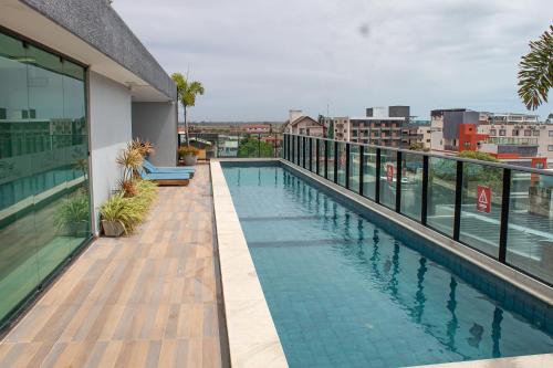 a swimming pool on the balcony of a building at Ocean Porto Flats in Porto De Galinhas