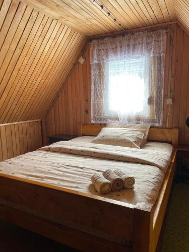 a large bed in a room with a window at Mountain House Jelovica in Berane