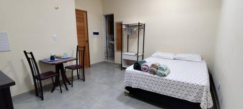 a bedroom with a bed and a table and a table and chairs at Studio Figueira, Flor in Santarém