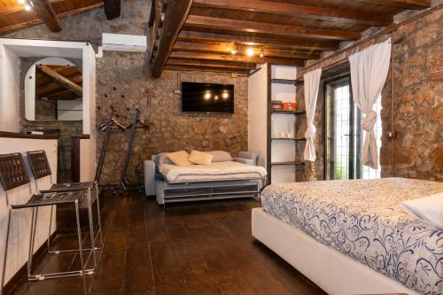 a bedroom with two beds and a television in it at Maestosa Maison della Cattedrale, 3 piani storici tutti per voi! in Sutri
