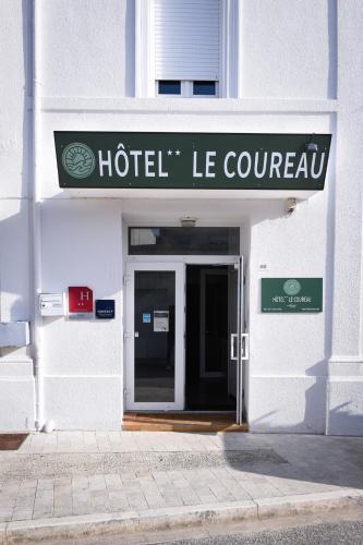 a building with a hotel le courvin sign on it at Hotel Le Coureau in Saint-Trojan-les-Bains