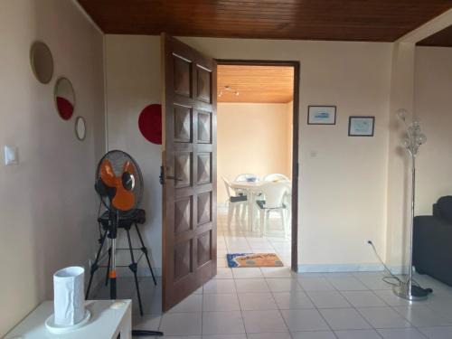 a view of a room with a door and a table at Roger et Micheline a Kaz in Le Carbet