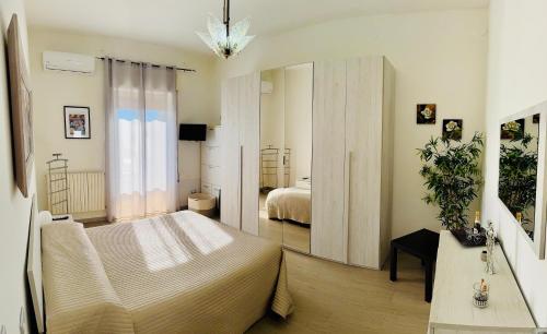 a bedroom with a bed and a large mirror at Casa tua a Pergusa in Pergusa