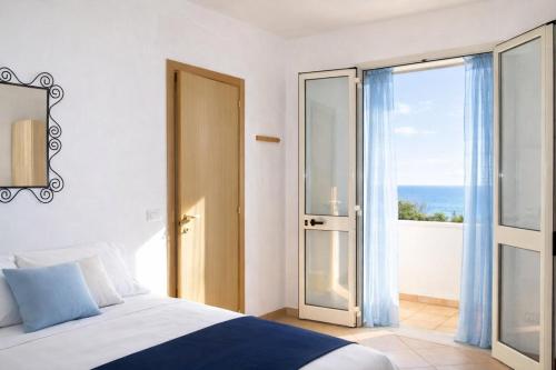 a bedroom with a bed and a view of the ocean at ONDA BLU-Appartamenti in Torre dell'Orso