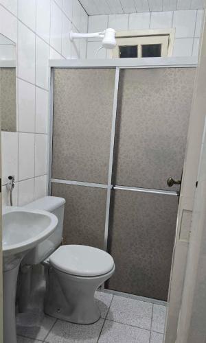 a bathroom with a shower with a toilet and a sink at Apto RUA DO LAZER in Santa Teresa