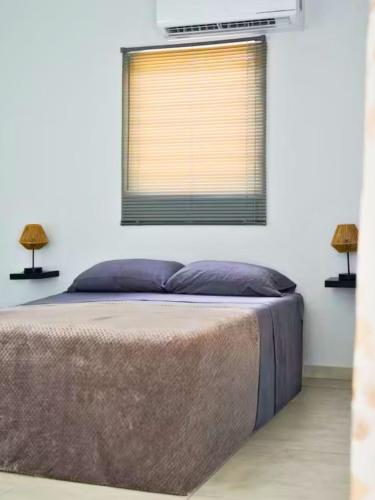 a bedroom with a large bed with a window at Santirome Studio 2 - Cozy Westpunt Escape for Two in Westpunt