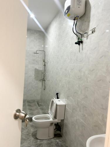 a small bathroom with a toilet and a shower at Dinems Apartment in Ikeja