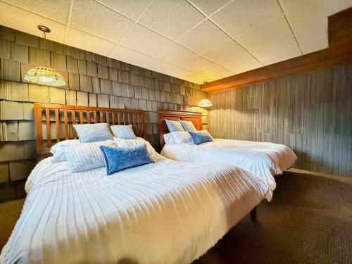 two twin beds in a room with at Fox's Den Your Lakefront Escape with Dock and Stunning Views in Rocky Mount