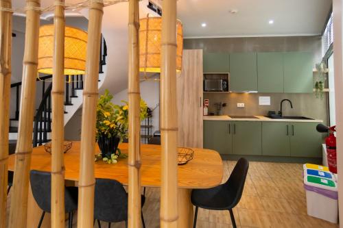 a kitchen and dining room with a wooden table at Central Guest House in Ponta Delgada