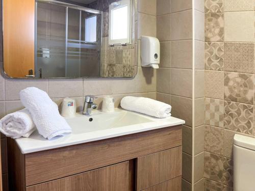 a bathroom with a sink and a mirror at Te Maná Hotel in Torreblanca
