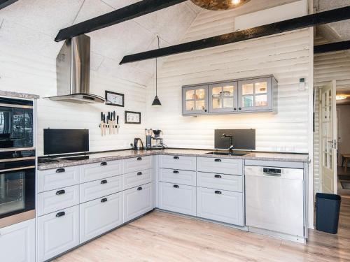 a kitchen with white cabinets and a counter top at 4 star holiday home in Blåvand in Blåvand
