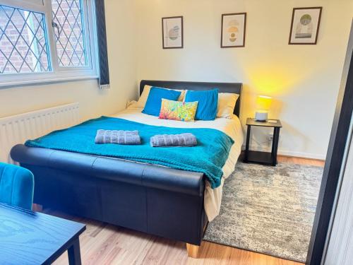 a bedroom with a large bed with two pillows on it at Very Spacious 4 Bedroom house with large garden in Leamington Spa