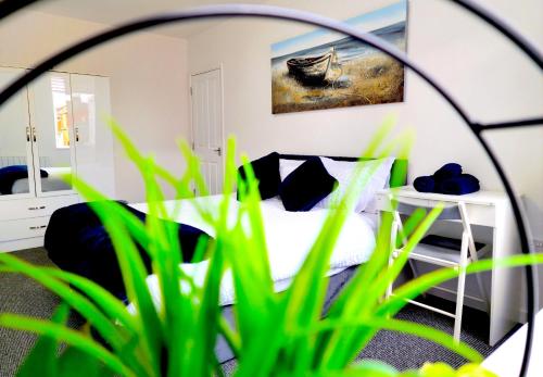 a bedroom with a bed and a mirror at Airy flat is the heart of Northampton in Northampton