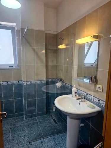 a bathroom with a sink and a shower at Sunny And Waves Apartment in Golem