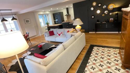 a living room with two white couches and a table at Le Hêtre Rouge - Écureuil et Geai Charme & Spa Alsace in Barr