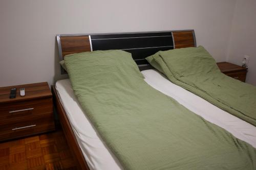 a bedroom with two beds and a night stand at BGD Rentals in Donji Milanovac