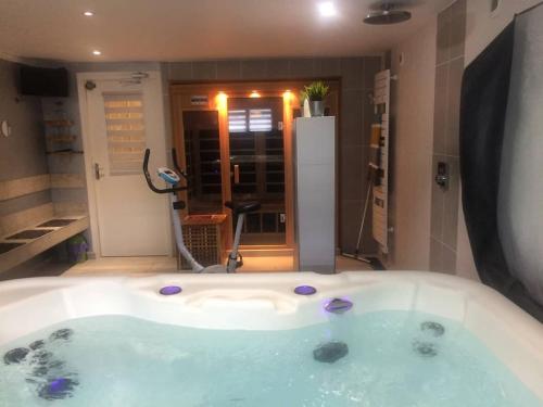 a large bath tub in a bathroom with at Gîte Nolan in Saint-Mesmin