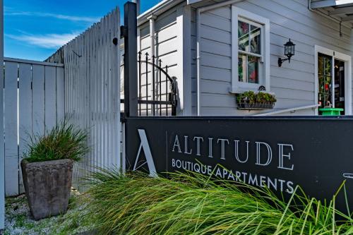 a sign in front of a white house at Altitude Apartment in Martinborough