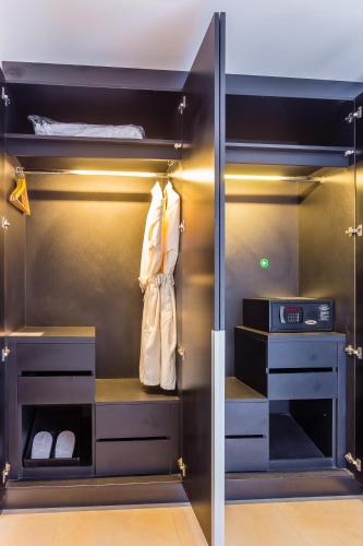 a walk in closet with a glass door at Nova Platinum Hotel in Pattaya South