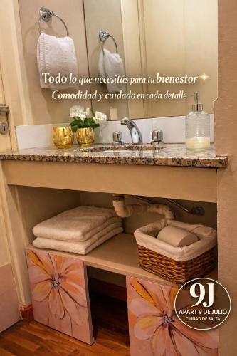 a bathroom with a sink and a counter with towels at Apart 9 de julio in Salta