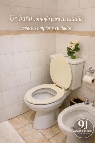 a bathroom with a toilet and a toilet paper dispenser at Apart 9 de julio in Salta