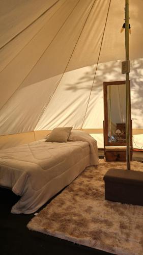 a bedroom with a tent with a bed and a mirror at Finca los ciervos in Apan