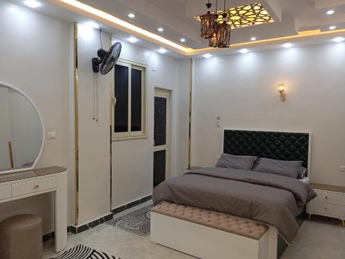 a bedroom with a bed and a mirror and a sink at Nour House in Luxor