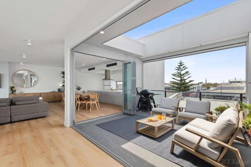 a living room with a couch and a table at Seaside Luxury - Panoramic Views in Heart of Town in Ocean Grove
