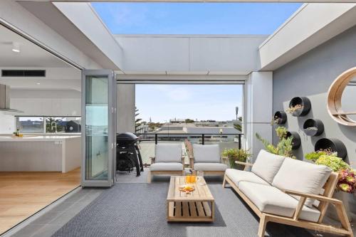 a living room with a couch and a table at Seaside Luxury - Panoramic Views in Heart of Town in Ocean Grove