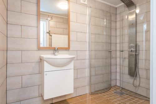 a bathroom with a sink and a shower at Yellow house in Skene