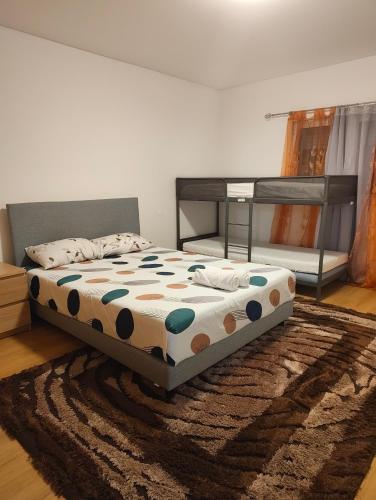 a bedroom with a bed and a rug at Leiria Tranquil Hideaway in Leiria