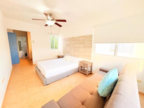 a bedroom with a bed and a couch at Estrella Azul Penthouse in Cancún