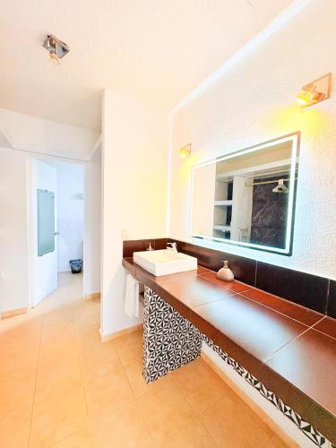a bathroom with a sink and a mirror at Estrella Azul Penthouse in Cancún