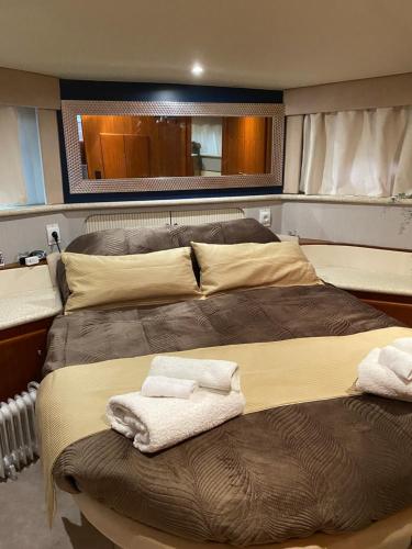 a bedroom with two beds with towels on them at Vilamoura -Boat in Quarteira
