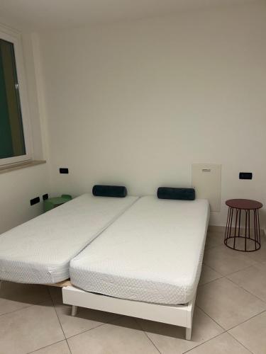 a white bed sitting in a room with at Nuvole e Miracoli - foresteria in Bagnolo Mella