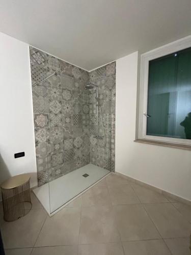 a bathroom with a shower with a glass wall at Nuvole e Miracoli - foresteria in Bagnolo Mella