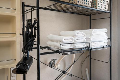 a towel rack with towels on it in a bathroom at アルカディアｋ in Aomori