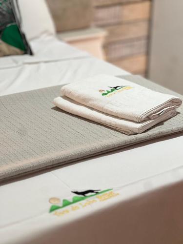 two towels are sitting on top of a bed at Toca do Lobo in Pirenópolis